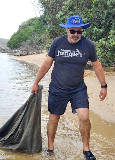Member Jungle’s CEO and Founder, Michael Barwell, dragging some rubbish out of a local river.